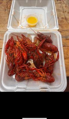 A to-go box of boiled crawfish with butter